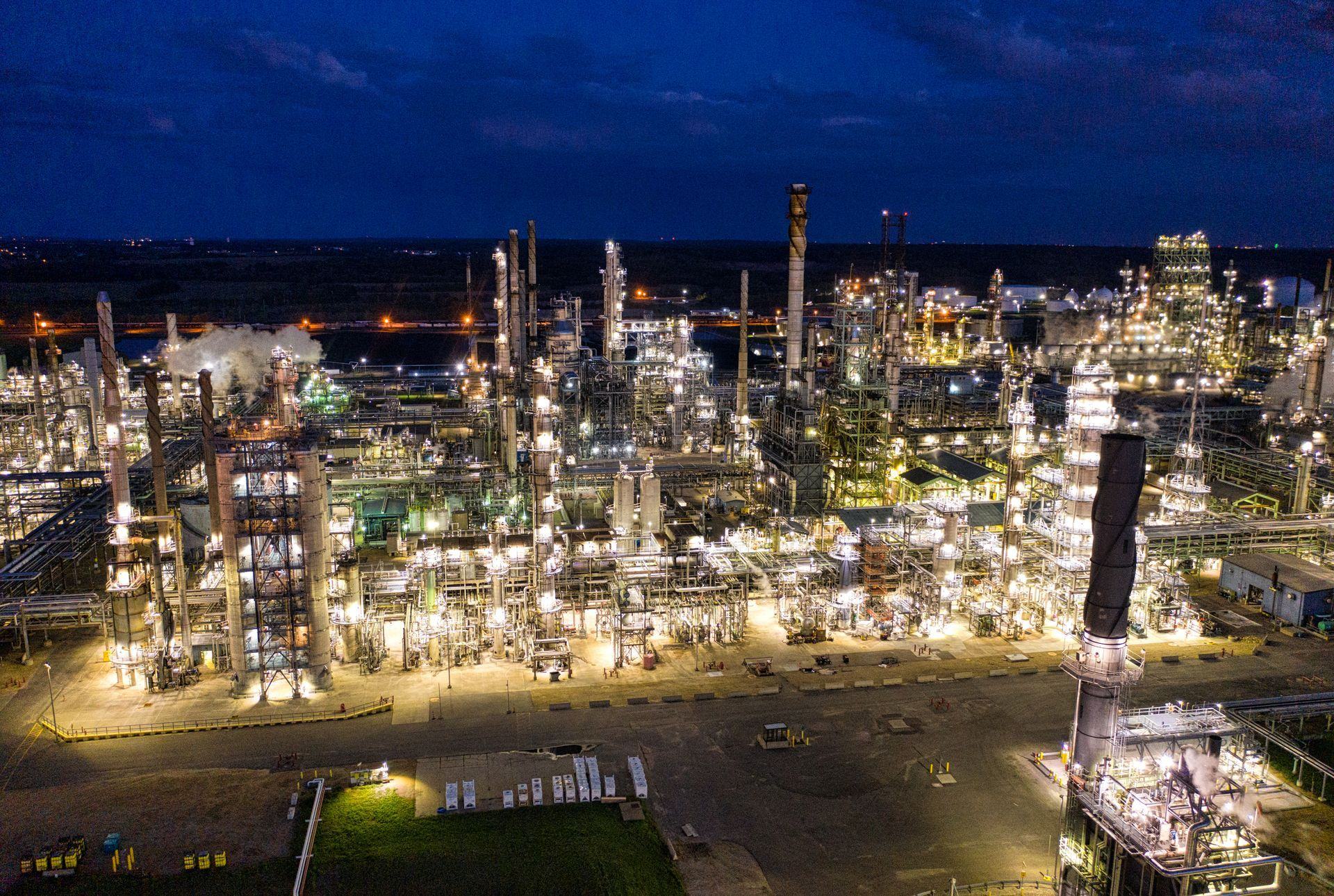 Industrial processing plant lit up at night, seen from above