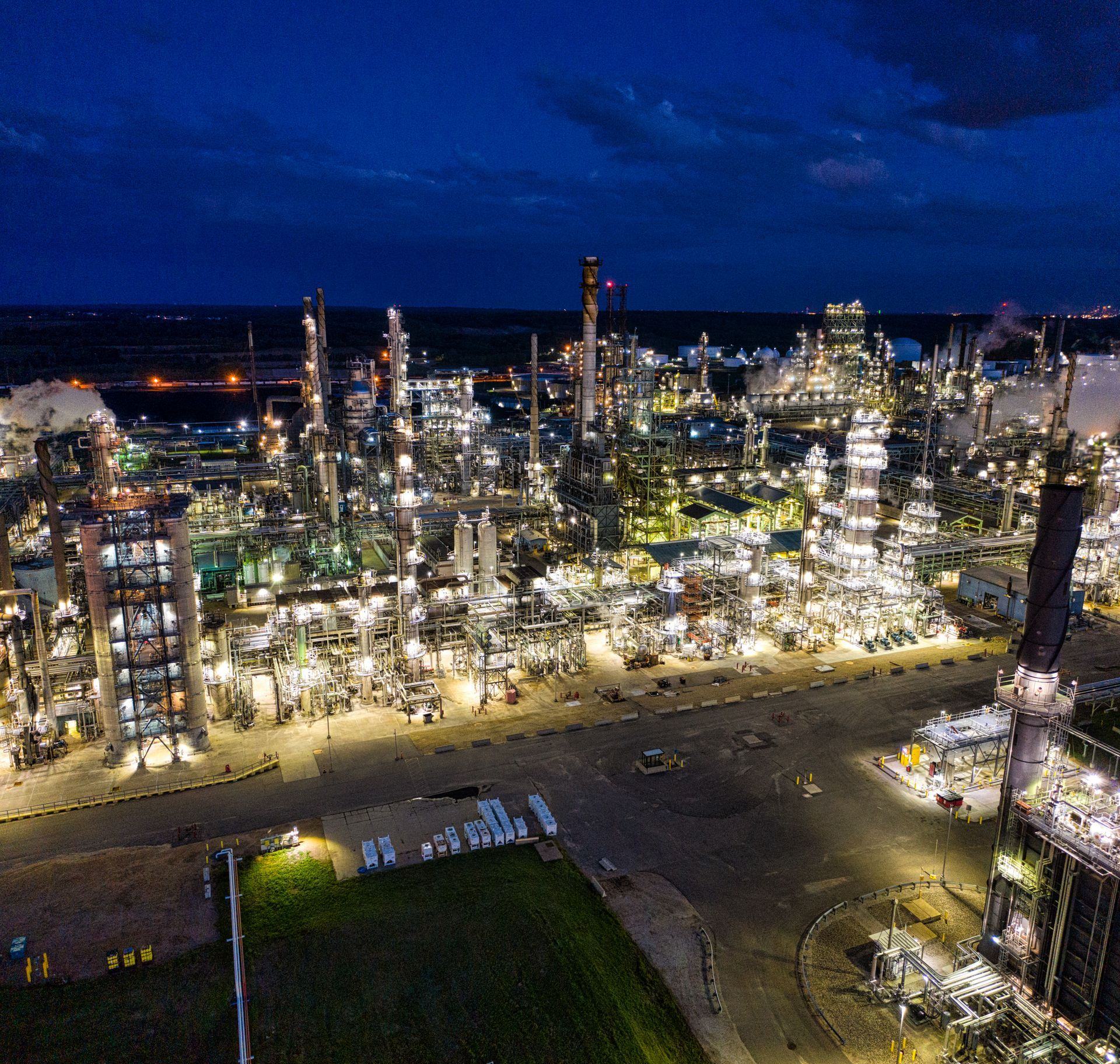 A refinery complex lit up at night, seen from above